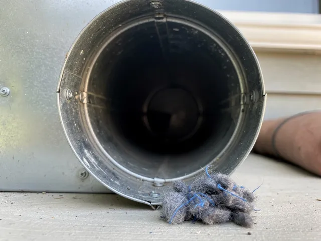 Los Alamitos Dryer Vent Cleaning technician using specialized equipment to clear severe dryer vent blockage in Los Alamitos